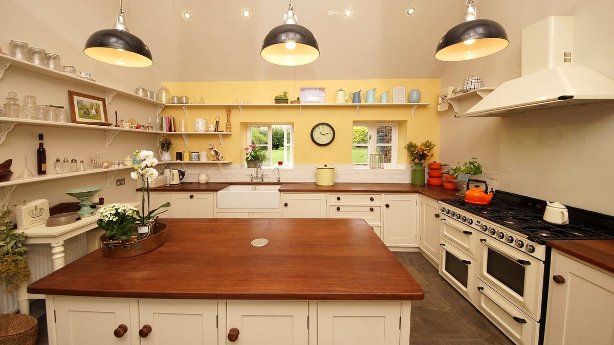 Farmhouse kitchen with wood countertops, open shelving and vintage decor