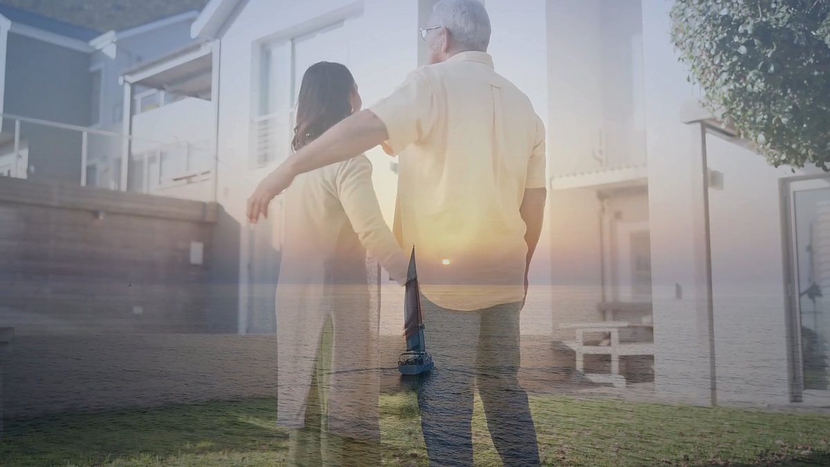 Couple looking out to the ocean at sunset from their home