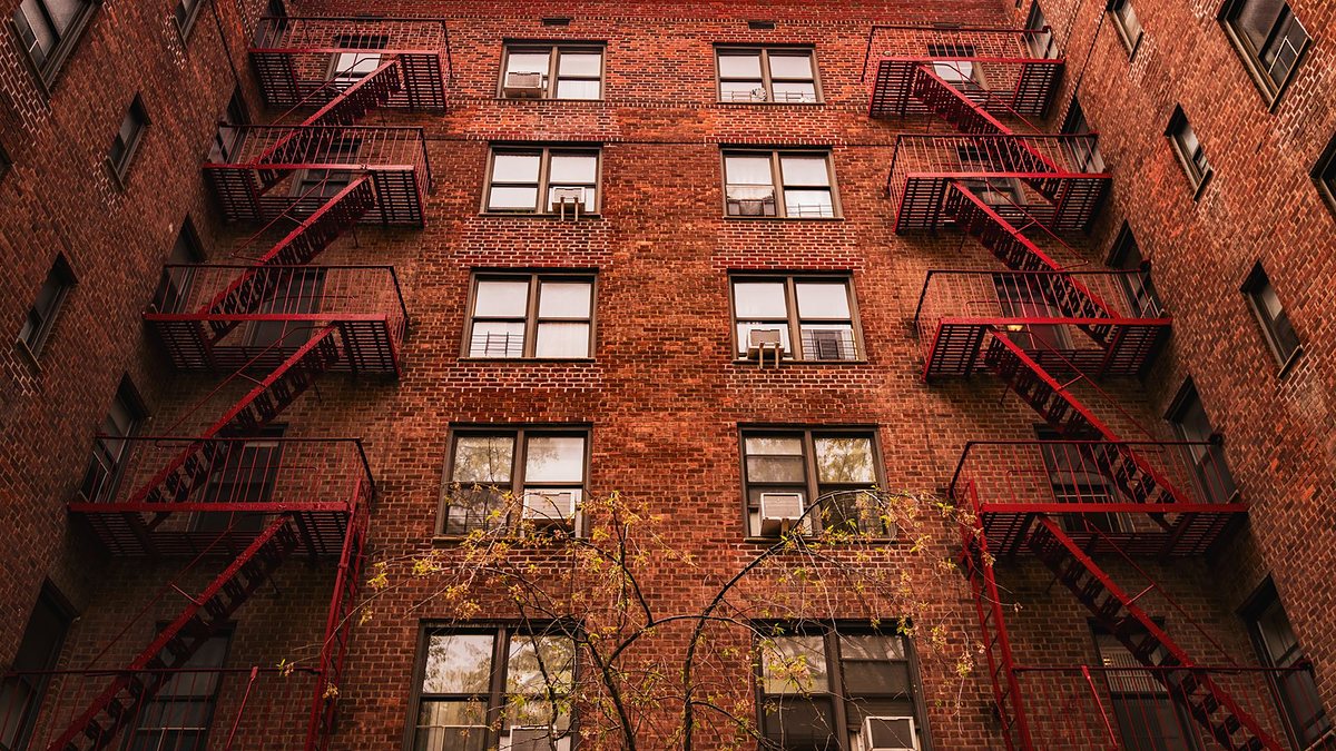 Red brick apartment buildings with fire escapes in New York