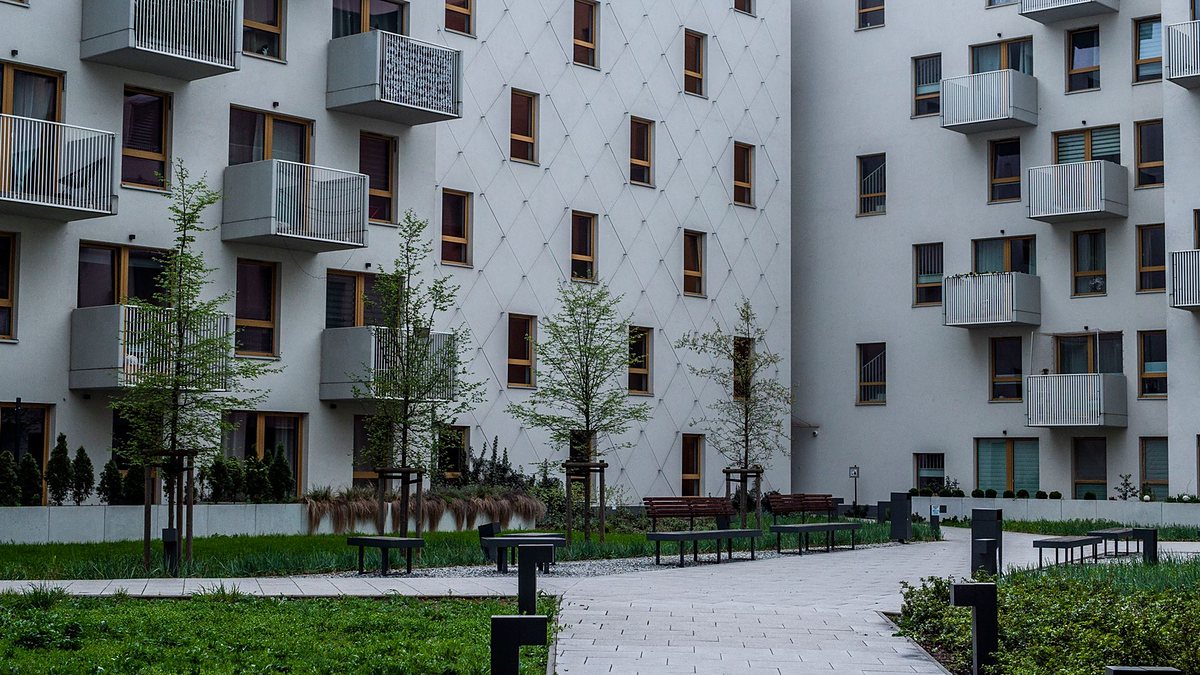 Contemporary apartment complex with a landscaped courtyard and balconies