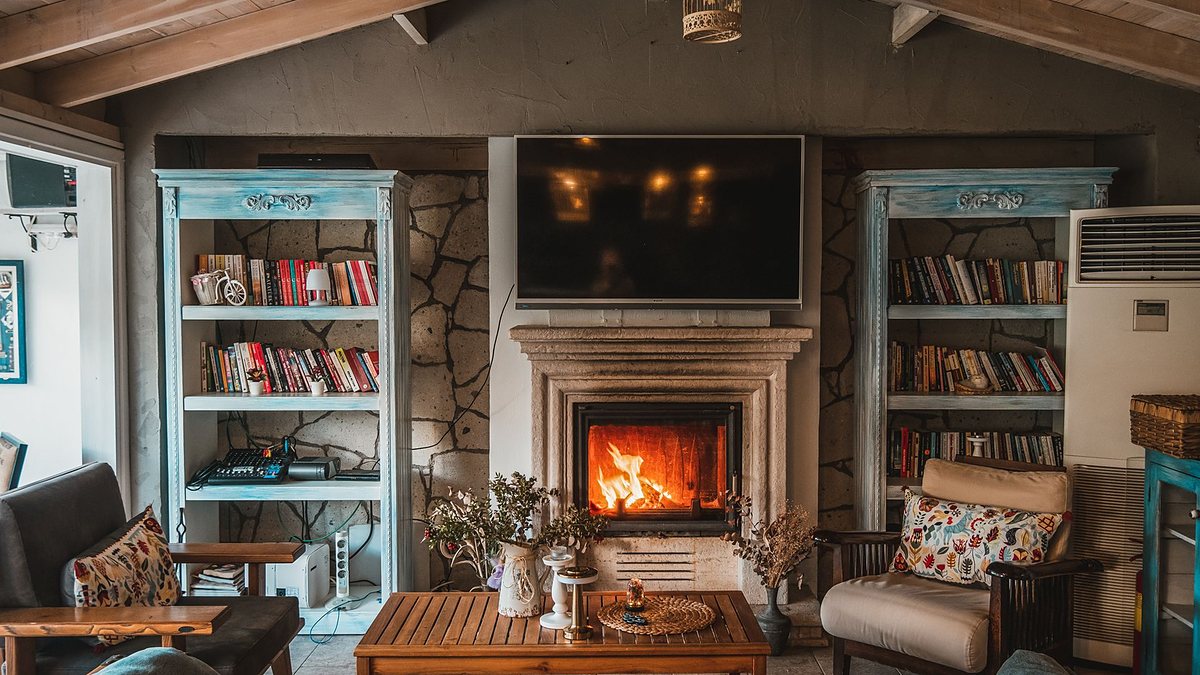 Warm, inviting living room with a cozy fireplace and decorative bookshelves